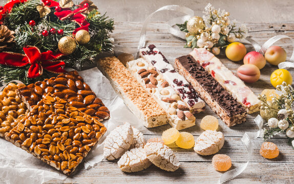 Italian Christmas desserts as different nougats with almonds, nuts, peanuts, marzipan. Traditional Italian Christmas sweets.