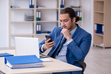 Young male employee working at workplace