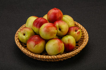Sweet small nectarines in the basket