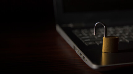 Fototapeta premium open security lock on laptop keyboard. Concept of Cyber security breach 