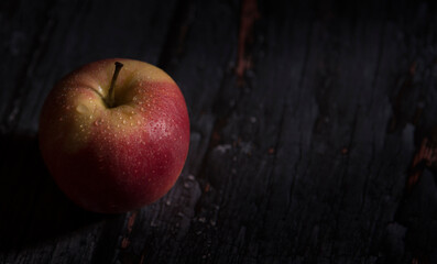 red apple on dark wooden background