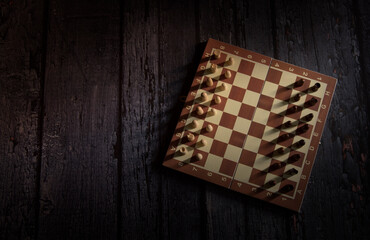 chess board on dark wooden table