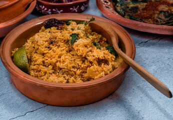 Mexican rice in adobo sauce served in clay bowl