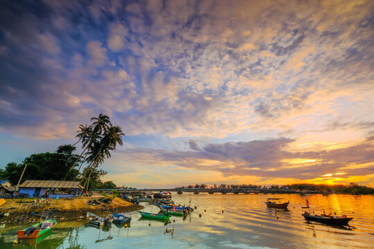 Parked fishing boat during sunset at Kuala Besut Terengganu Malaysia. Image contain grain , noise and soft focus