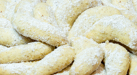 Fresh baked Vanilla Cookies. German sweet food - Vanillekipferl with vanilla powder sugar. close-up