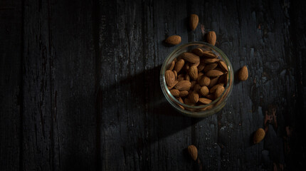 almond in bowl on dark wooden table