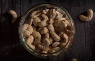cashew nuts in bowl on dark wooden table