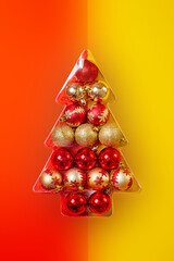 colored christmas balls laid out in the shape of a christmas tree