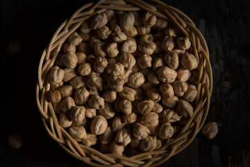 white chickpeas in basket on dark wooden table