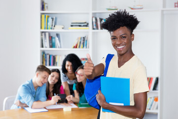 African american male student with eyeglasses and group of international students