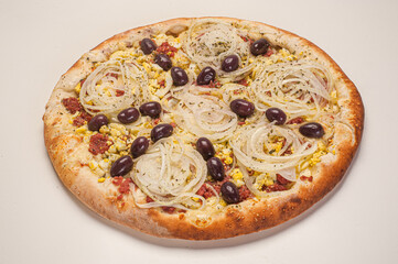 Traditional Brazilian pizza with Portuguese flavor, with mozzarella, eggs, onion, ham and olives on white background