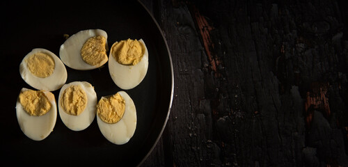 boiled eggs on dark wooden table
