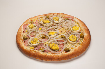 Traditional Brazilian pizza with Portuguese flavor, with mozzarella, eggs, onion, ham and olives on...