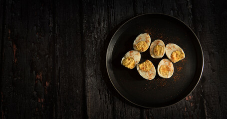 boiled eggs with spice on dark wooden table