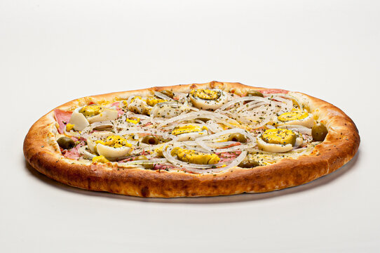 Traditional Brazilian pizza with Portuguese flavor, with mozzarella, eggs, onion, ham and olives on white background