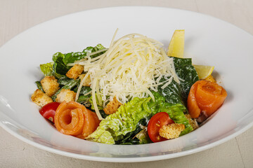 Caesar salad with salmon and cheese