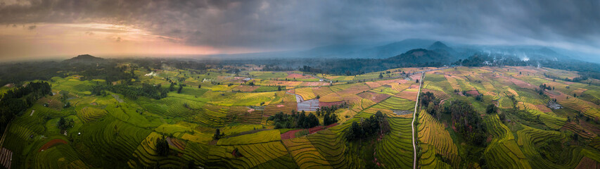 panoramic view of rice terraces from aerial photos in the afternoon when the sun is a beautiful and overcast sunset with Mount Bengkulu Utara, Indonesia