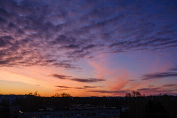 dramatatic red dark sunset over the fields and cities