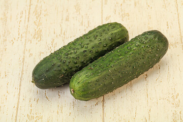 Green fresh cucumbers over background