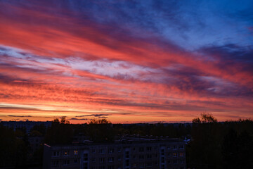 dramatatic red dark sunset over the fields and cities