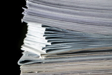 bundles bales of paper documents. stacks packs pile on the desk in the office on black background
