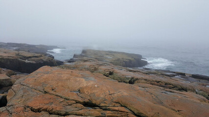view of Maine sea waves and fantastic rock in fog weather at Maine, United States