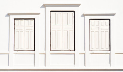 Three white windows on white wall