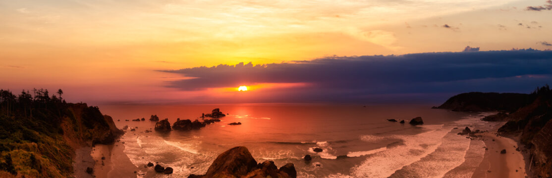 Ecola State Park, Cannon Beach, Oregon, United States. Beautiful Panoramic View of the Sandy and Rocky Beach on Pacific Ocean Coast. Dramatic Sunset Sky.