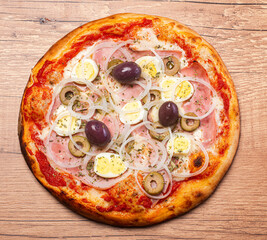 Traditional Brazilian pizza with Portuguese flavor, with mozzarella, eggs, onion, ham and olives on...