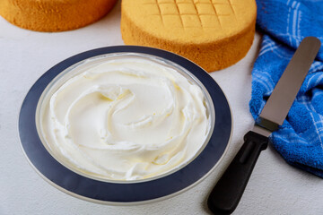 Frosting with spatula and egg cake for making wedding cake.