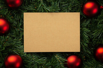 Merry christmas kraft paper note mockup template with pine leaves decorations.