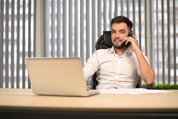 Office director talking on phone with colleagues and partners
