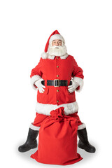Santa Claus poses in a festive mood next to a bag full of gifts. Santa claus in full growth on an isolated white background.