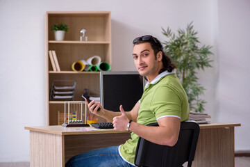 Fototapeta premium Young male designer working in the office