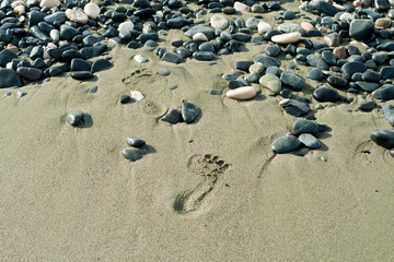 Fototapeta na wymiar Footprints on beach sand