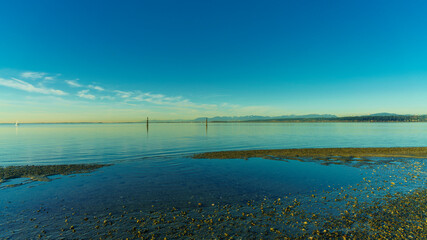Tranquil Boundary Bay, BC, late afternoon, looking across to Tsawwassen from pebble-strewn beach at...