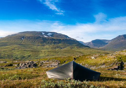Tent in the wilderness of Scandinavia in front of mountains