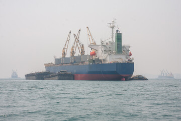A large container ship sailed in the middle of the sea.