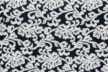 Woolen fabric with an abstract pattern in black and white. As a natural background.