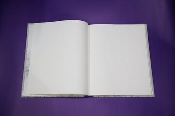 A open clear note book isolated on purple or violet background