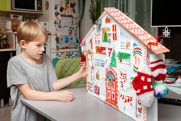 House-advent-calendar handmade from packing cardboard. Eco-friendly Christmas, recyclable, zero waste, seasonal activities for kids.