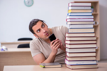 Young male student preparing for exams at library