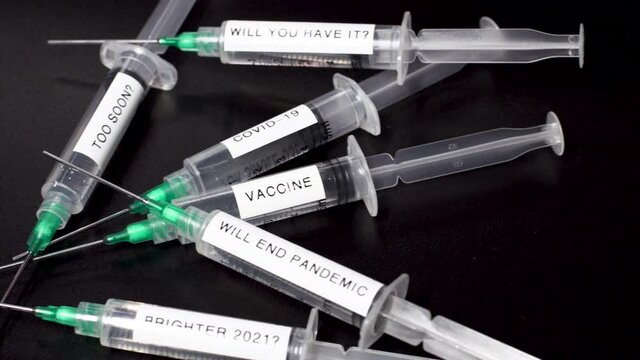 Vaccine Research For Coronavirus Covid-19, Pan to Syringes with an important messages 4K