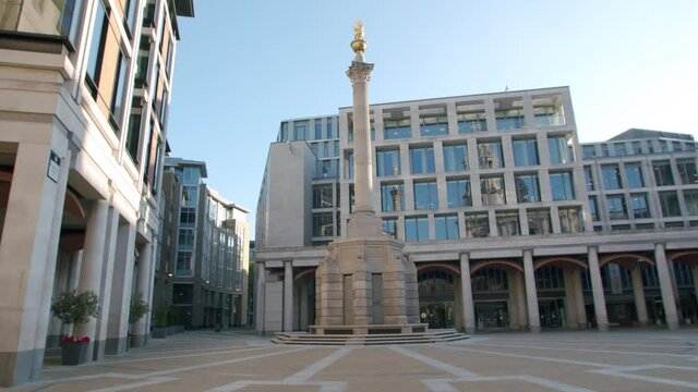 Lockdown in London, stunning desolate Paternoster Square monument in golden morning sunrise light and blue sky's, during the coronavirus pandemic 2020.