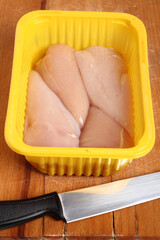 Chicken breast in disposable plastic packing box