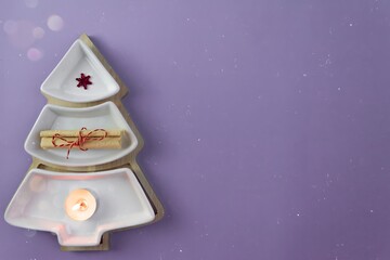 Merry Christmas and Happy New Year. Layout concept for congratulations, place for text, Christmas tree with burning candle and sweets