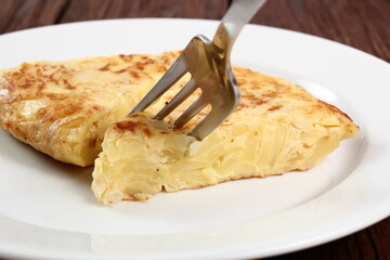 Eating Spanish omelette. Macro.