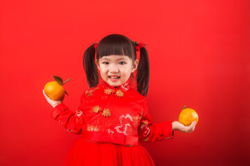A Chinese girl holding oranges for the Spring Festival