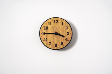Fototapeta na wymiar wood office wall clock with white dial on white background. wall clock on white background, top view.