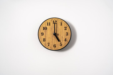 wood office wall clock with white dial on white background. wall clock on white background, top view.